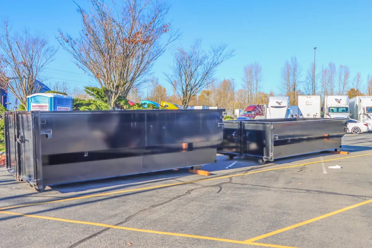 Professional dumpster rental service with roll-off container on residential driveway in Pacific Grove